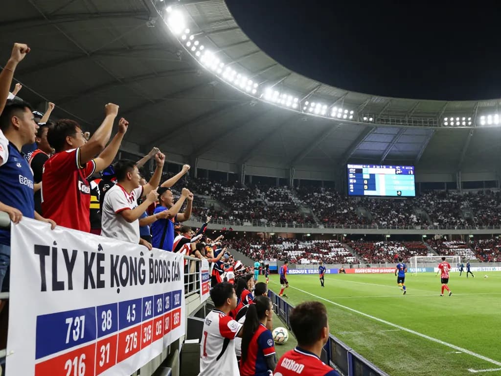 Exciting football match atmosphere showcasing tỷ lệ kèo bóng đá with fans cheering and dynamic gameplay.